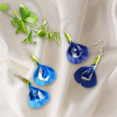 Handcrafted Clay Butterfly Pea Flower Earrings in Light and Dark Blue Embrace the enchantment of nature with our "Enchanted Blooms" earrings, featuring the delicate beauty of the butterfly pea flower, now immortalized in clay. Handcrafted with precision and care, these earrings come in two captivating shades: a serene light blue reflecting the sky at dawn, and a rich dark blue reminiscent of the deep ocean. Perfect for adding a touch of botanical elegance to any outfit, these earrings are not ju Blue Drop Earrings With Handmade Flowers, Blue Handmade Flower-shaped Earrings, Blue Handmade Flower Drop Earrings, Handmade Flower Blue Jewelry As Gift, Blue Handmade Flower Jewelry For Gifts, Handmade Blue Flower Jewelry For Gifts, Blue Handmade Flower Jewelry As Gift, Elegant Blue Birth Flower Earrings, Nature-inspired Blue Dangle Earrings