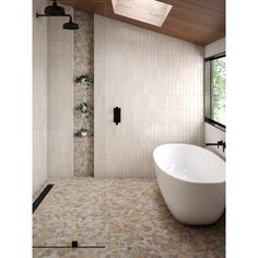 a bath tub sitting next to a shower in a bathroom under a skylight on the ceiling