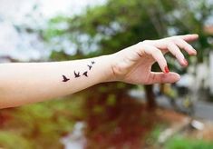 a woman's arm with birds on it and the word love written in black ink