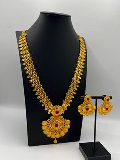 Embrace regal elegance with our exquisite 24K gold-plated Rani Haar set, a true masterpiece designed for the modern queen. This luxurious jewelry set, inspired by traditional royal designs, is perfect for weddings, special occasions, or adding a touch of grandeur to your collection. Care Instructions: To maintain the pristine condition of your Rani Haar set, avoid direct contact with water, perfumes, and harsh chemicals. Store in a dry, cool place when not in use. Luxury Necklaces For Diwali Puja, Luxury Gold-plated Necklace For Puja, Luxury Gold Plated Necklace For Puja, Luxury 22k Gold Meenakari Necklace, Luxury Gold Bollywood Mala, Bollywood Style 22k Gold Jewelry Set, Elegant Heavy Gold Jewelry Set, Formal Gold-plated Meenakari Temple Necklace, Formal Gold Kundan Jewelry Sets