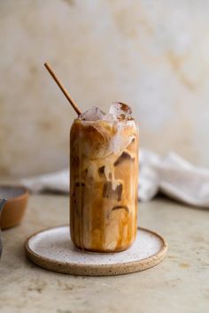 an iced drink on a plate with a wooden stick sticking out of it's top