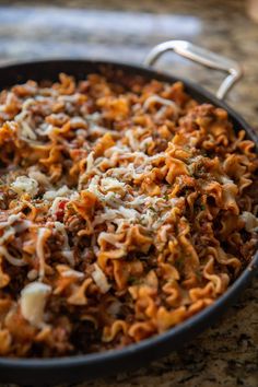 a pan filled with pasta and cheese on top of a counter