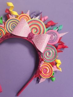 a pink headband with colorful candies on it