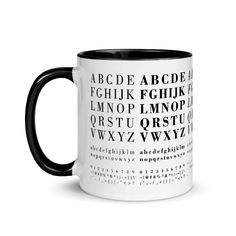 a black and white coffee mug with letters