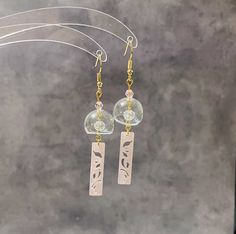 Elevate your style with these handmade earrings - an ideal blend of culture, craftsmanship, and elegance. They're perfect for any occasion!  🤍 Handmade with high-quality hollow glass charms, finished with 18K gold plated nickel free hypoallergenic earring hooks. They look stunning and eye-catching. We are now offering three colours of pendants for your choice! 🤍 Japanese wind chimes, also known as "Furin," which are believed to bring good luck and positive energy. Whether you're a fan of Japan Elegant Clear Earrings As Gift, Unique Rose Gold Earrings, Handmade Clear Earrings For Wedding, Traditional Rose Gold Earrings For Gift, Handmade Adjustable Earrings For Celebration, Handmade Clear Drop Earrings, Clear Drop Earrings For Anniversary, Rose Gold Earrings For Celebration, Handmade Drop Earrings For Anniversary