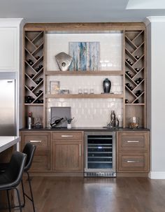 a kitchen with an oven, wine rack and counter top in the middle of it