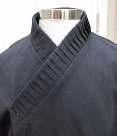 a close up of a person's black shirt on a mannequin dummy