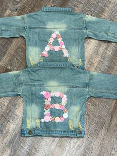 two children's jean jackets with flowers on them