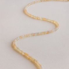 Illuminate your summer look with our Opal Beaded Necklace, featuring opals that capture and reflect light with a mesmerizing iridescence. Each bead shimmers with a radiant glow, adding a touch of bohemian charm and beauty to your sunny day style. SKU: RR-NR221 Product Details Material: High Quality Solid 925 Sterling Silver Finish: 18K Gold Featuring a ~4mm Natural Opal Beaded Necklace on an adjustable 16 to 18 inch chain Featured Styles Part of our Opal Collection Model showcases the perfect la Natural Opal, Snake Chain, Solid 925 Sterling Silver, Summer Looks, Opal, 18k Gold, Beaded Necklace, 925 Sterling Silver, Beads