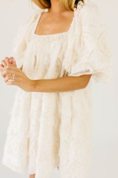 have your main character moment with this dreamy ivory puff sleeve mini dress. featuring dainty lace trim details + an elegant square neckline, this dress has heirloom-quality energy. from bridal showers to dinner dates, it’s guaranteed to be your new go-to. off white // mini length, scoop neckline, elastic neckline, lined, front bow detail, pockets, elastic cuffs model is 5'8" + wearing a small measurements are approximate + taken while laying flat xsmall : bust 32” length 31.5” small : bust 34 Lace Mini Dress With Puff Sleeves For Wedding, Feminine Cream Puff Sleeve Dress With Square Neck, Cream Lace Trim Dress With Square Neck, Cream Puff Sleeve Dress With Ruffles And Square Neck, Feminine Cream Mini Dress With Square Neck, Cottagecore Wedding Dress With Square Neck, Cream Square Neck Dress With Lace Trim, White Square Neck Mini Dress In Cottagecore Style, Cream Lace Trim Square Neck Dress