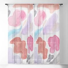 a window curtain with pink and grey flowers on it, hanging from a white wall