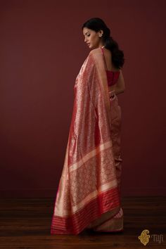 "\nWith its rich floral web of zari, this regal\u00a0saree is truly representative of the royal clothing traditions of India. A luxurious piece of handwoven art!\n\n\n\nColor\u00a0- A ravishing shade of\u00a0Red\n\nTechnique\u00a0- Classic handwoven Banarasi Zari Vasket art passed down through generations.\n\nFabric\u00a0- Soft as butter, pure Katan Silk\n\nSpeciality\u00a0- A beautiful web of silver zari all over\u00a0the body and a rich border and pallu.\u00a0Age-old Banarasi artistry.\u00a0\n\nTilfi Promise\u00a0- Pure. Handloom. Banaras.\n\nNote\u00a0- The saree comes with its own blouse piece. The\u00a0model is wearing a separate blouse for styling purposes.\n\n\n\u00a0\nSince\u00a0this product is handwoven, there might be slight irregularities. But don't you think these add to the si Royal Clothing, Katan Silk, Banarasi Saree, Banarasi Sarees, Shades Of Red, Sheer Blouse, Blouse Piece, Affordable Fashion, Silk Sarees