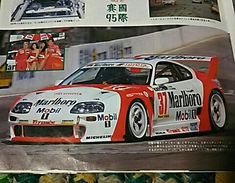 the front page of a magazine with an image of a racing car on it's side