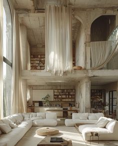 a living room filled with lots of white furniture