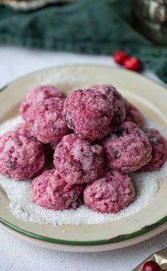 a white plate topped with cookies covered in powdered sugar on top of a table