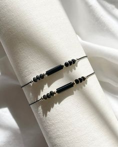 Experience the perfect blend of style and elegance with our Women's Contemporary Adjustable Silk Cord Natural Crystal Bracelet. This exquisite piece features stunning Shungite & Onyx, expertly combined with your choice of either 18K gold-filled or 925 sterling silver accents. 925 Sterling silver and 18k gold-filled components deliver lasting quality and durability. Gold-filled is made by bonding gold to a base metal, resembling solid gold without the high cost and resist tarnish and wear, ensuring your jewellery stays beautiful for years. The soft, comfortable silk cord is easily adjustable to fit any wrist size, ensuring a secure and personalized fit. African Turquoise is known for its transformative and grounding properties, while Moonstone is celebrated for its feminine energy and intui Crystal Healing Bracelets, Silk Cord, Cord Bracelets, Silver Gifts, Crystal Bracelet, Silver Accents, Healing Crystal, Crystal Bracelets, Natural Crystals