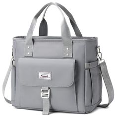 a gray bag with straps and handles on the front, sitting against a white background