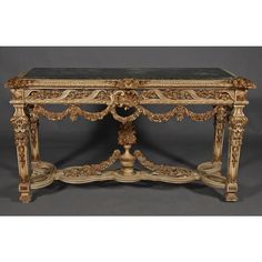 an ornately decorated console table with marble top