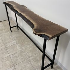 a wooden bench sitting on top of a tiled floor