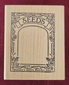 a rubber stamp with the words seeds on it and an arch in the middle, surrounded by flowers