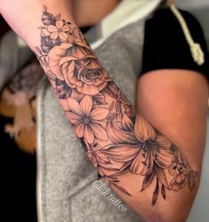 a woman with a flower tattoo on her arm