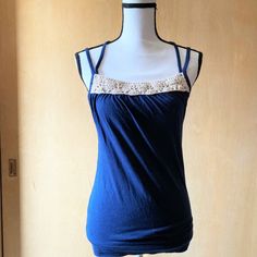 Nwot Sz S Tank Top For Tommy Jeans. The Color Is Dark Blue And It Has Cream Crochet On The Front Of The Neckline. It Has Double Straps That Cross In The Back. Measurements Are 32 Inches Under The Arms, 30 Inches Around The Bottom Hem, And 21 Inches Long From Top Hem To Bottom Hem Excluding Straps. Summer Blue Tops With Lace Trim, Navy Cotton Tank Top For Spring, Fitted Navy Tank Top For Spring, Spring Stretch Top By Tommy Hilfiger, Tommy Hilfiger Stretch Top For Spring, Spring Tommy Hilfiger Stretch Top, Navy Fitted Summer Top, Tommy Hilfiger Stretch Tops For Summer, Fitted Tommy Hilfiger Tops For Summer