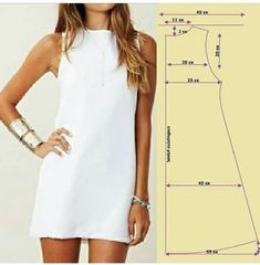 a woman in a white dress is standing next to a drawing and measurements for her body