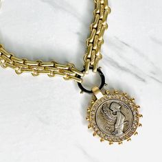 Our Avril Silver Coin is set in a matte gold bezel with cz crystals set along the coin perimeter. Multi Link chain is brass with decorative matte gold finish, all metals are free from cadmium, lead and nickel. Measures 18” long, lobster clasp closure, adjustable chain. Sterling silver charm holder can be opened to add and remove charms. Gunmetal finish. Coin Pendant Necklace, Gold Choker Necklace, Gold Choker, Silver Coin, Custom Jewelry Design, Freshwater Pearl Necklaces, Champagne Gold, Coin Pendant, Silver Coins