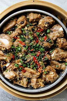 a bowl filled with meat and vegetables on top of a table