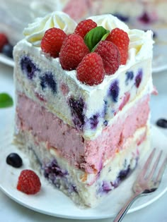 there is a piece of cake with berries on the top and blueberries on the bottom