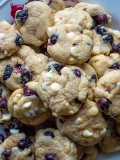 a white plate filled with cookies and cranberries