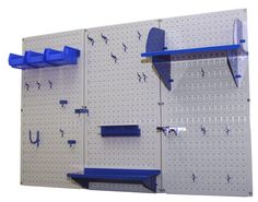 there are several pegboard shelves on the wall with blue brackets and hooks attached to them