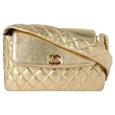 Chanel Rare Limited Edition 1994 Runway Gold Metallic Quilted Lambskin Flap 1994 {VINTAGE 28 Years} 2 Interior pockets 6" H x 10" W x 3" D Handle Drop: 20" Made in France Chanel Handbags Red, November Style, Chanel 90s, Vintage Chanel Bag, Chanel Top, Structured Shoulder, Lavender Aesthetic, Vintage Chanel Handbags, Gold Glam