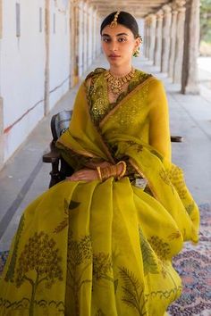 Mustard pure silk saree with scallop border and kalamkari in forest design. Paired with embroidered, kalamkari sleeveless blouse.
Component: 2
Pattern: Embroidered, Hand Painted
Type Of Work: Mirror, Kalamkari
Neckline: V Neck
Sleeve Type: Sleeveless
Fabric: Saree: Pure Silk
Color: Yellow
Other Details: 
Mirror work
Floral motifs
Scallop border
Occasion: Wedding
Disclaimer: This product will be exclusively handcrafted, making the colour/texture/pattern slightly vary from the image shown, due to Archana Jaju, Mirror Saree, Yellow Mirror, Fancy Sarees Party Wear, Simple Sarees, Kalamkari Saree, Saree Designs Party Wear, Yellow Saree, Indian Dresses Traditional