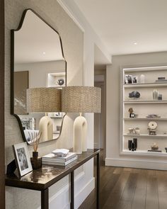 a living room filled with furniture and a large mirror