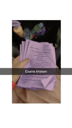 someone is holding up some papers in their hand with the words exam khatam written on it