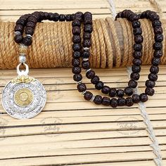 🌟 Welcome to our enchanting collection! Dive into the rich spiritual heritage with our stunning 108 Nepali Aged Black Rudraksha Beads Necklace! 📿 Each bead in this necklace carries the essence of time, aged to perfection to enhance its sacred energy and spiritual potency. 🌿 ✨ At the heart of this divine necklace lie two Om metal beads--one nestled at the midway point and another adorning the end of the mala. The Om symbol, representing the universal sound of creation, serves as a beacon of se Spiritual Jewelry For Rituals And Festivals, Spiritual Necklaces With 108 Beads For Rituals, Traditional 108 Beads Jewelry Gift, Traditional Brown Engraved Jewelry, Spiritual Round Beads Jewelry For Puja, Traditional Jewelry For Meditation With 8mm Beads, Spiritual Silver Beaded Necklaces For Puja, Spiritual Necklaces With Silver Beads For Puja, Traditional 8mm Beads Jewelry For Meditation