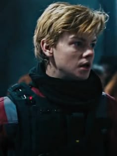 a young man with blonde hair wearing a red and black jacket in the movie spider - man