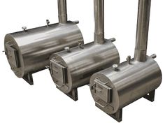 three stainless steel tanks sitting next to each other