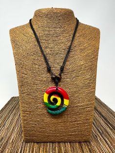 Explore the timeless appeal of our Spiral Necklace, a piece designed to embody the concepts of new beginnings, spirituality, peace, and tranquility. This unisex accessory is meticulously crafted to suit any gender and style, making it a versatile addition to both casual and formal outfits. Color Options: Choose from a diverse palette including classic white, sleek black, vibrant rasta, rich cocoa bean, natural brown, and edgy distressed black. Design Features: - Adjustable Comfort: The necklace Rasta Necklace, Spiral Necklace, Rasta Colors, Formal Outfits, Handcrafted Necklace, Unisex Accessories, Resin Pendant, Spiritual Jewelry, Formal Outfit