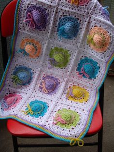 a crocheted blanket sitting on top of a chair