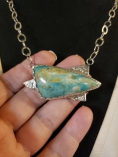 "A beautiful, natural, UNTREATED stone - PERUVIAN OPAL! Beautiful blue-ish green color The freeform Trillion Cabachon measures 45x23mm; the overall pendant measures 2\" across, and 1\" top to bottom. It is bezel set with a scalloped edge, and completely handcrafted. We attached it to an open cable link chain, with a lobster claw clasp. It can be attached at any length, up to a maximum of 20\". Hallmarked 925 Contact me with any questions" Chrysocolla Necklace With Large Pendant As Gift, Untreated Green Bohemian Necklace, Artisan Green Necklace With Large Stone, Silver Chrysocolla Necklace With Large Stone, Unique Green Chrysocolla Necklaces, Untreated Green Pendant Necklace, Green Chrysocolla Necklace With Large Pendant, Nature-inspired Green Necklaces With Large Stone, Nature-inspired Green Necklace With Large Stone