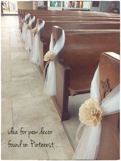 two rows of pews decorated with white tulle and bows