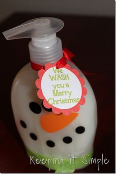 a hand sanitizer is sitting on a table with a tag that says wash you a merry christmas