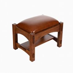 a wooden bench with a leather seat on it's back legs and foot rest