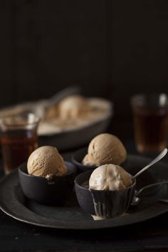 three scoops of ice cream on a black plate