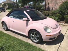 a pink car is parked on the side of the road