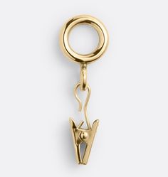 a gold charm with the letter v hanging from it's end, on a white background