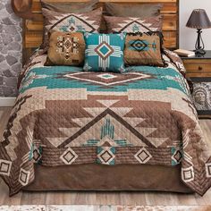 a bed covered in a brown and turquoise blanket