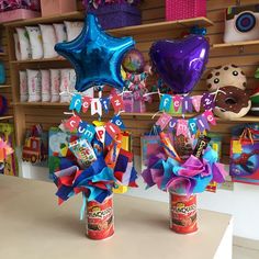 two vases filled with candy and balloons